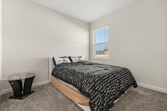 carpeted bedroom with baseboards