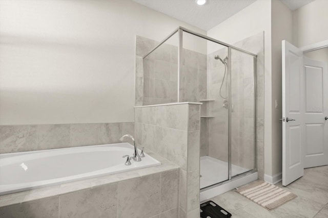 full bathroom featuring a shower stall, tile patterned flooring, and a bath