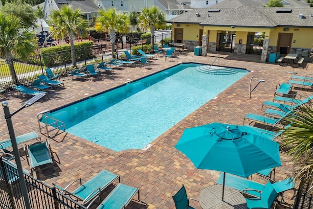 community pool featuring fence and a patio area