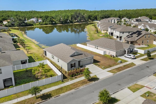 aerial view featuring a residential view, a water view, and a forest view