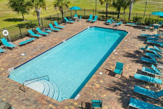 pool featuring fence and a patio area