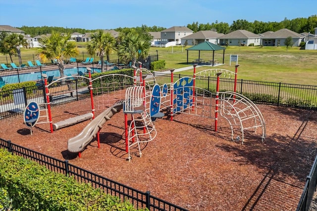 communal playground featuring a residential view, a yard, a gazebo, and fence