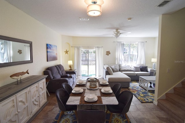 626 Verona Ave, Davenport, FL 33897 - dining room featuring a ceiling fan, visible vents, dark tile patterned floors, and a textured ceiling