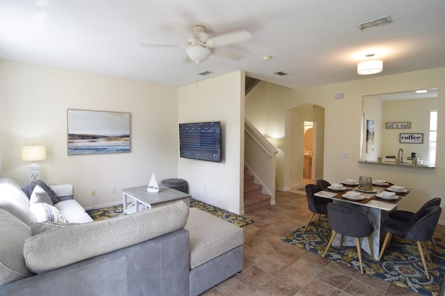 626 Verona Ave, Davenport, FL 33897 - living area featuring arched walkways, a ceiling fan, stairs, and visible vents
