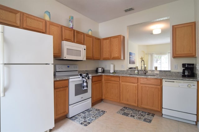 626 Verona Ave, Davenport, FL 33897 - kitchen featuring a sink, light tile patterned floors, visible vents, light stone counters, and white appliances