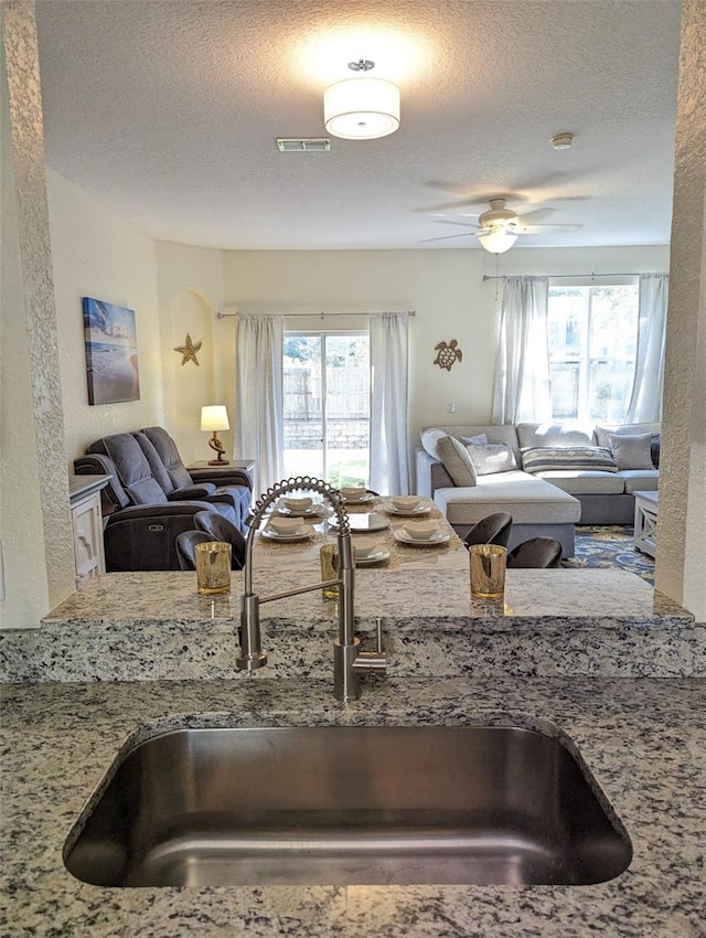 626 Verona Ave, Davenport, FL 33897 - kitchen featuring a sink, a healthy amount of sunlight, visible vents, a textured ceiling, and open floor plan