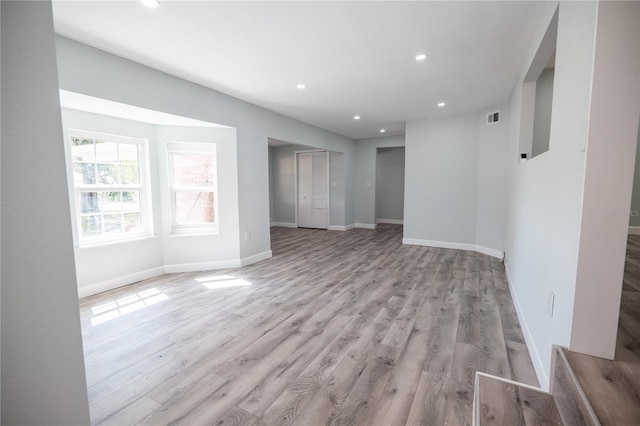 unfurnished living room with recessed lighting, baseboards, visible vents, and light wood-style floors
