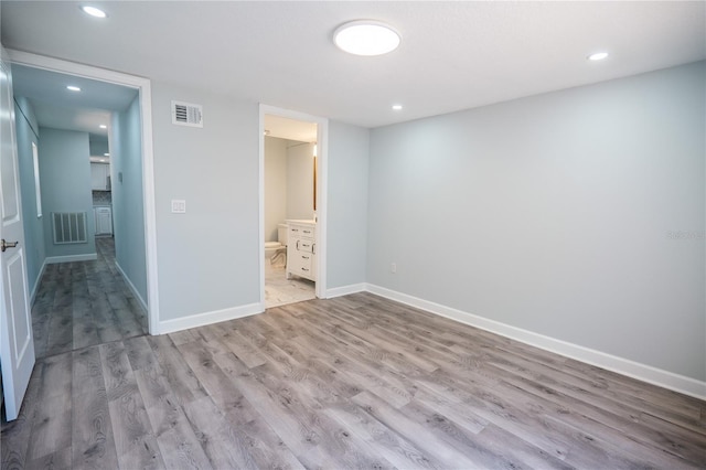 unfurnished bedroom with visible vents, recessed lighting, baseboards, and wood finished floors