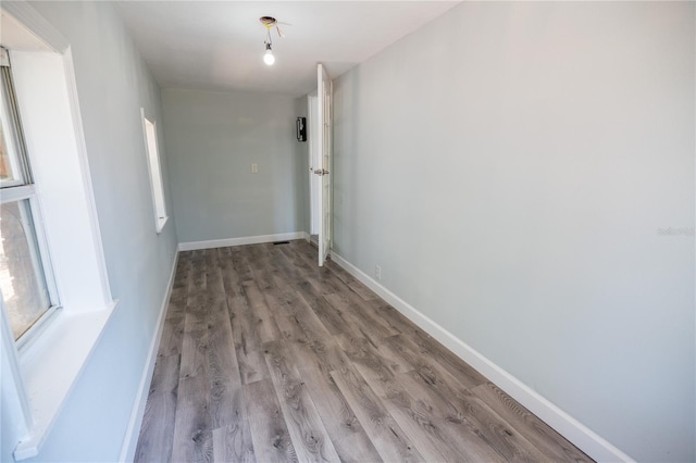 hall featuring baseboards and light wood-style flooring