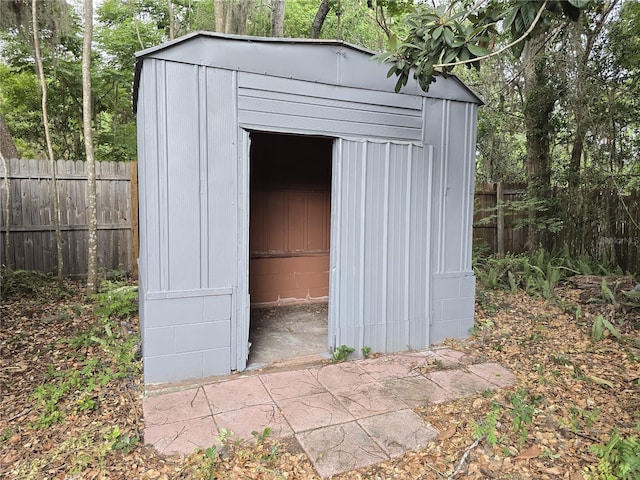 view of shed featuring fence