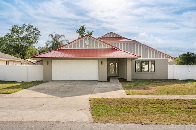view of front of property featuring stucco siding, fence, a garage, driveway, and a front lawn