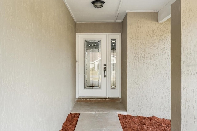 property entrance with stucco siding