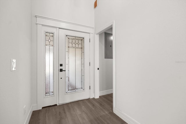 entryway with electric panel, wood finished floors, and baseboards