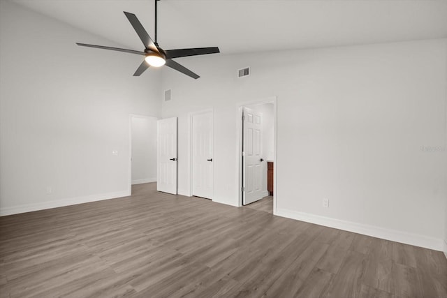 unfurnished bedroom featuring wood finished floors, visible vents, and baseboards
