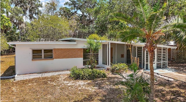 view of front of property with a sunroom