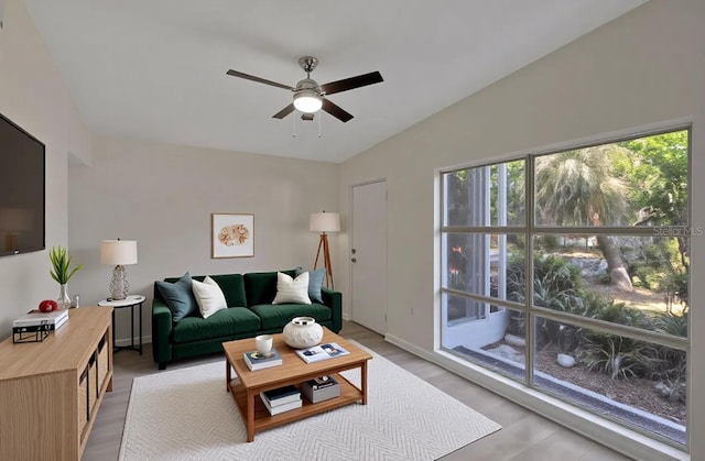 living area with ceiling fan and light wood finished floors