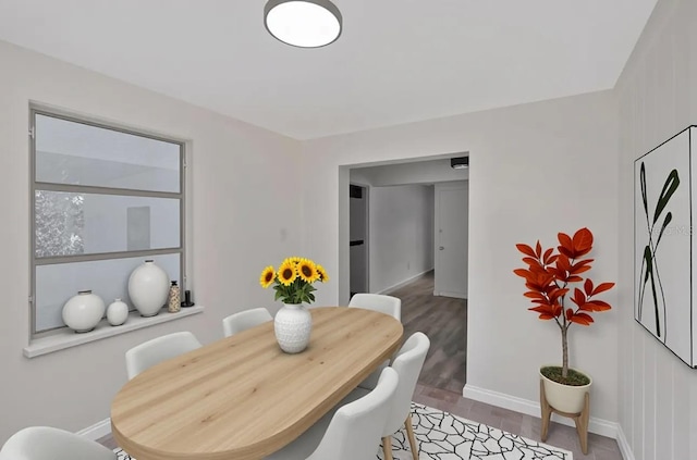 dining room featuring light wood finished floors and baseboards