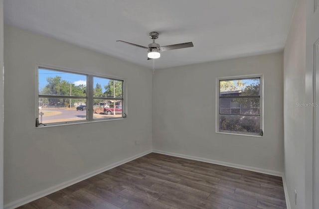 empty room featuring ceiling fan, wood finished floors, and plenty of natural light