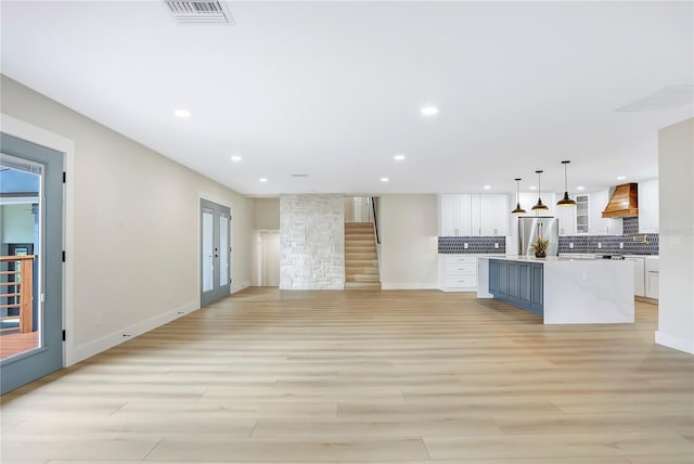40 W Laurel St, Apopka, FL 32703 - unfurnished living room with baseboards, visible vents, light wood-type flooring, and recessed lighting