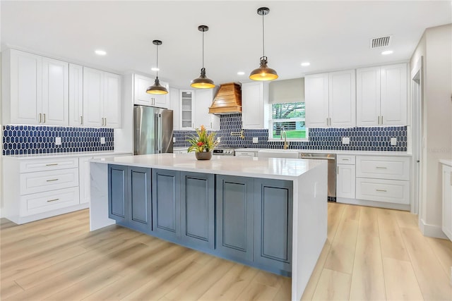 40 W Laurel St, Apopka, FL 32703 - kitchen featuring white cabinetry, stainless steel appliances, and custom exhaust hood