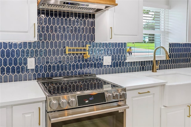 40 W Laurel St, Apopka, FL 32703 - kitchen featuring exhaust hood, a sink, stainless steel electric range oven, backsplash, and white cabinetry