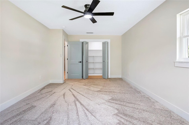 40 W Laurel St, Apopka, FL 32703 - unfurnished bedroom with baseboards, ceiling fan, a closet, and carpet flooring
