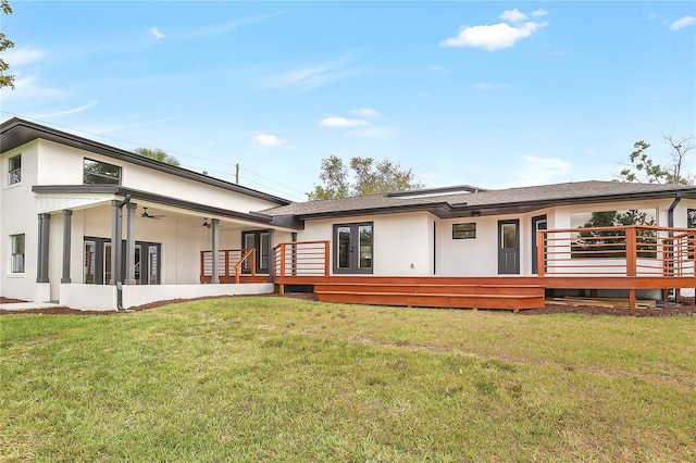 40 W Laurel St, Apopka, FL 32703 - back of house with stucco siding, a ceiling fan, a lawn, and a wooden deck
