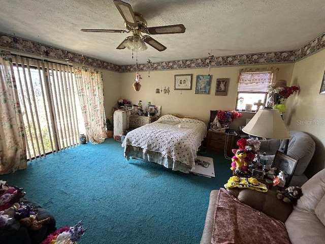 bedroom featuring carpet floors, a ceiling fan, and a textured ceiling