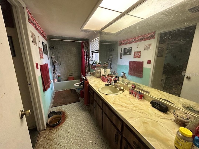 bathroom with vanity, shower / bathtub combination with curtain, and tile patterned floors