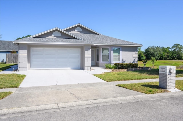 ranch-style house with fence, a shingled roof, a garage, a front yard, and driveway