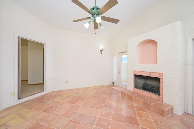 unfurnished living room with a ceiling fan, lofted ceiling, and a fireplace