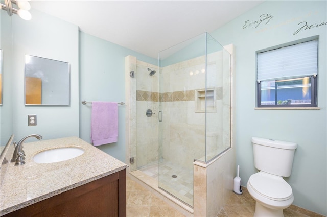 full bath with vanity, tile patterned floors, a stall shower, and toilet