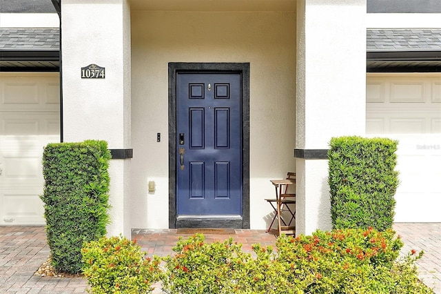 entrance to property with stucco siding
