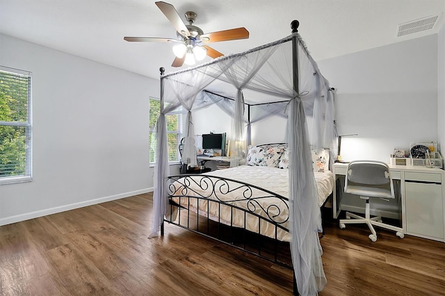bedroom with wood finished floors, visible vents, ceiling fan, and baseboards