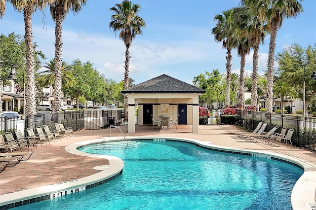 community pool featuring fence and a patio area