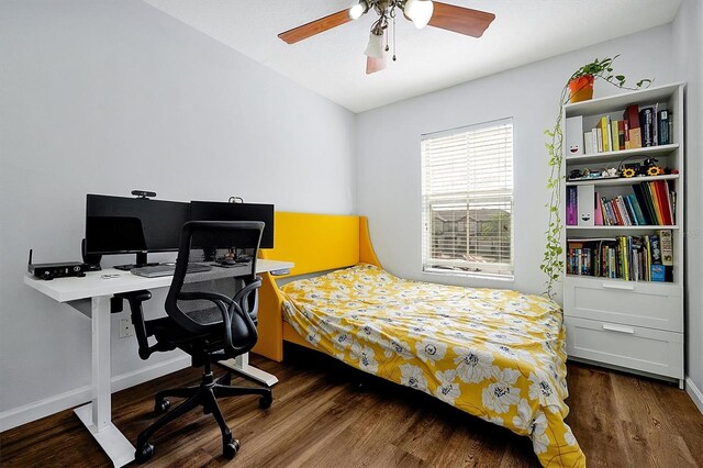bedroom with a ceiling fan, wood finished floors, and baseboards