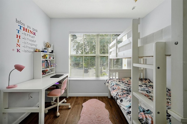bedroom featuring baseboards and wood finished floors