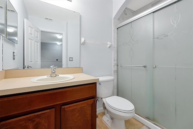 bathroom with visible vents, a shower stall, toilet, and vanity