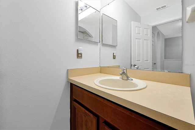 bathroom featuring visible vents and vanity
