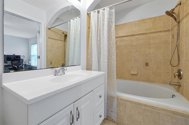 bathroom featuring vanity and tiled shower / bath