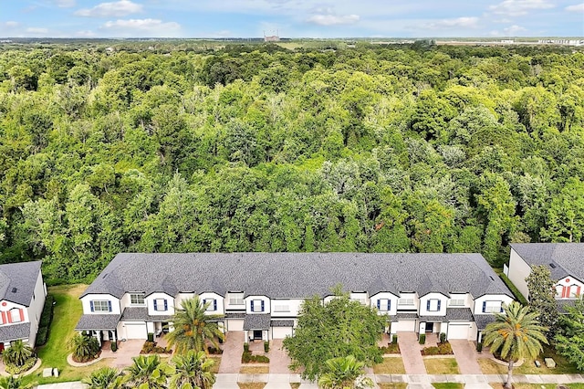 drone / aerial view with a residential view and a forest view