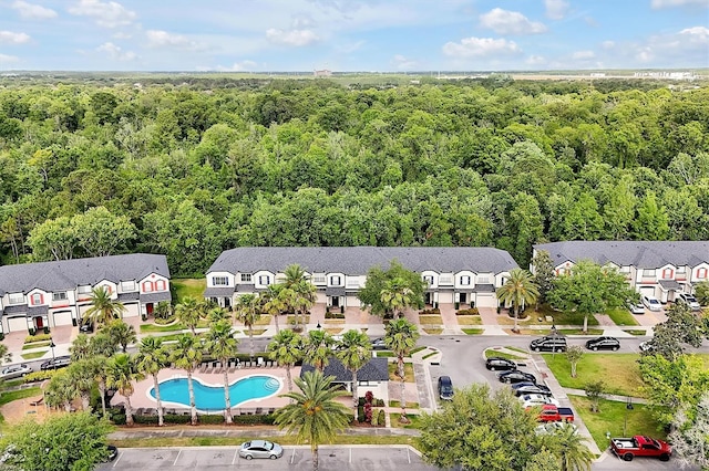 birds eye view of property with a view of trees and a residential view