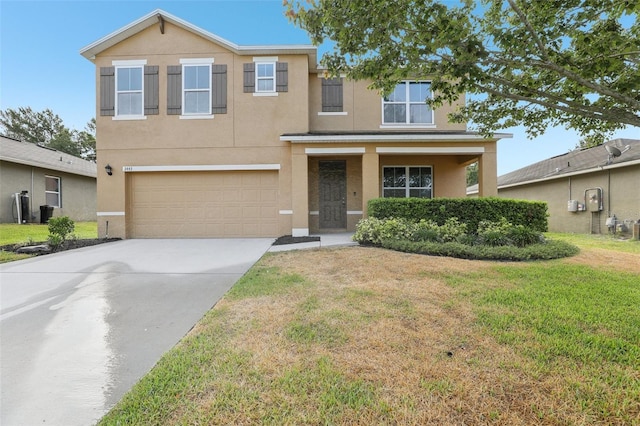 traditional home featuring a garage, stucco siding, concrete driveway, and a front lawn