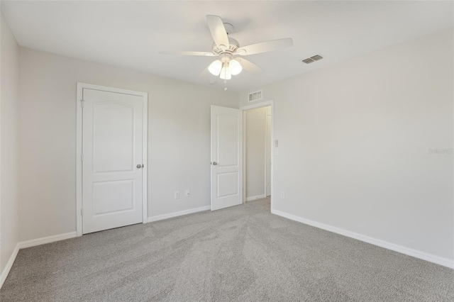 unfurnished bedroom featuring visible vents, carpet flooring, and baseboards