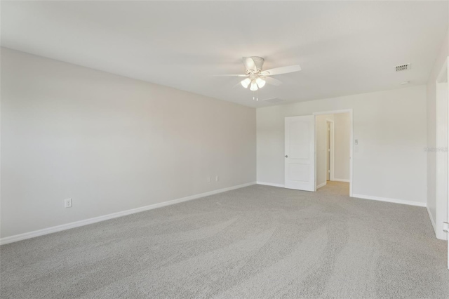 unfurnished room featuring carpet floors, ceiling fan, visible vents, and baseboards
