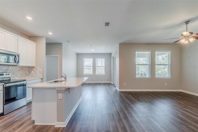 507 Daylily Blvd, Nokomis, FL 34275 - kitchen featuring appliances with stainless steel finishes, open floor plan, a sink, dark wood finished floors, and recessed lighting