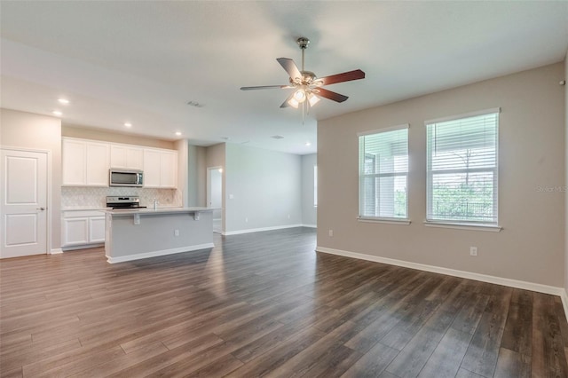507 Daylily Blvd, Nokomis, FL 34275 - unfurnished living room with dark wood-style floors, ceiling fan, baseboards, and recessed lighting