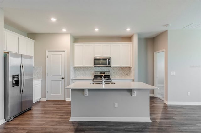 507 Daylily Blvd, Nokomis, FL 34275 - kitchen featuring appliances with stainless steel finishes, tasteful backsplash, a sink, dark wood finished floors, and light countertops