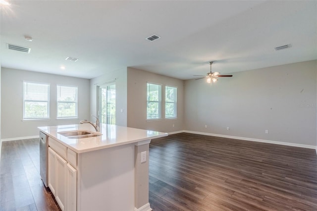 507 Daylily Blvd, Nokomis, FL 34275 - kitchen with a sink, stainless steel dishwasher, dark wood-style floors, baseboards, and a center island with sink
