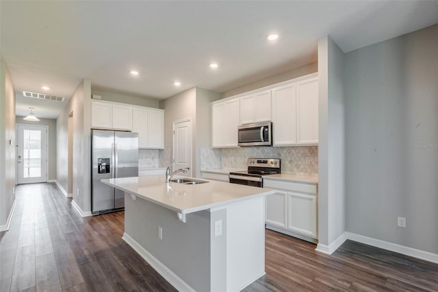 507 Daylily Blvd, Nokomis, FL 34275 - kitchen with stainless steel appliances, a sink, a kitchen island with sink, dark wood-type flooring, and recessed lighting